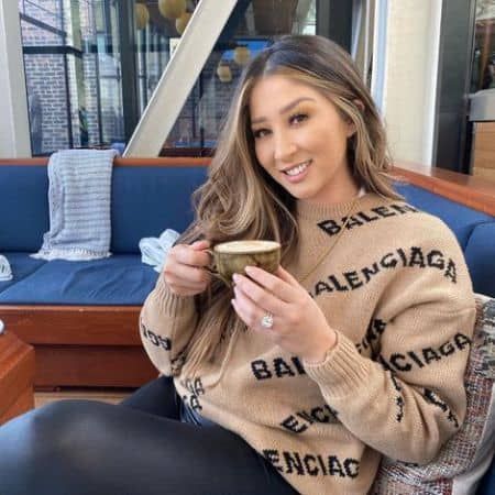 She is drinking a cup of tea in this picture.